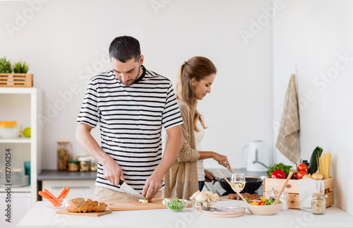 couple cooking food at home kitchen