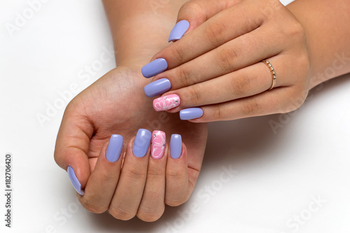 summer colored purple, pink manicure with white flowers and crystals on long square nails on a white background


