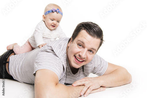 Young dad is enjoying time with his childgirl in studio white background photo