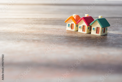 Miniature house on wooden background.Image for property real estate investment concept.
