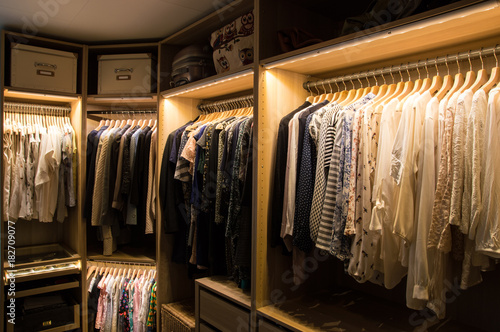 Luxurious walk in closet with lighting and jewelry display. photo