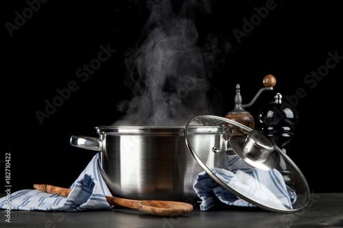 Obraz na plátně Steaming pot on black background