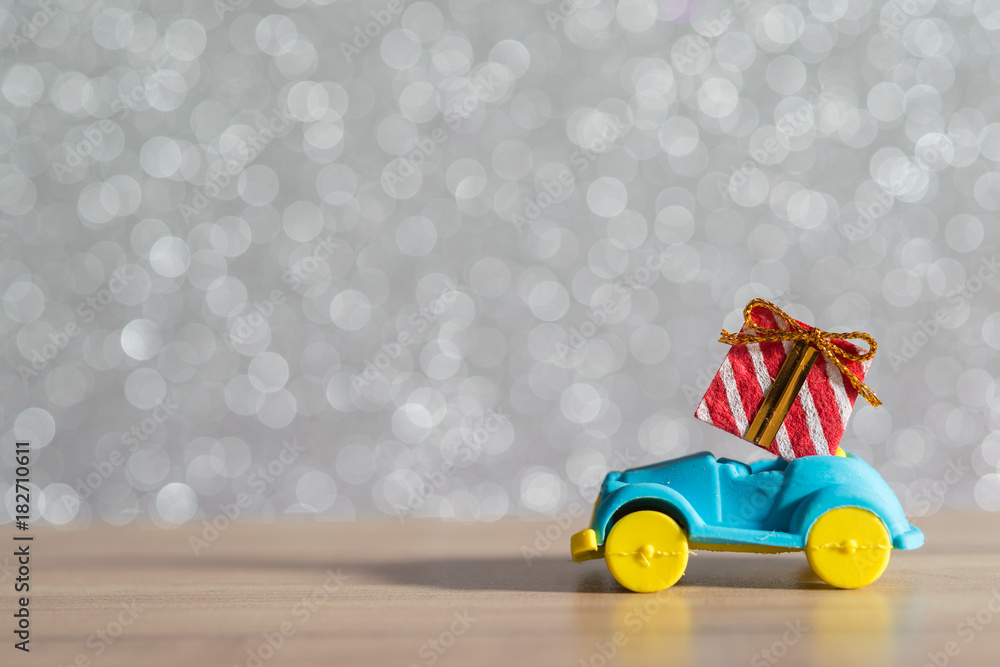 Toy Car with Christmas tree and gift box. Christmas landscape with gifts and snow. Merry christmas and happy new year greeting card with copy-space. Christmas celebration holiday background. Toy Car with Christmas tree and gift box. Christmas landscape with gifts and snow. Merry christmas and happy new year greeting card with copy-space. Christmas celebration holiday background.