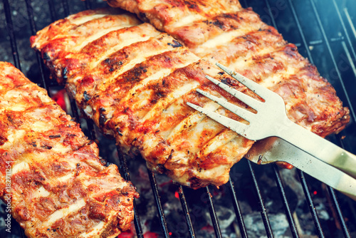 Spare ribs cooking on barbecue grill. Food background