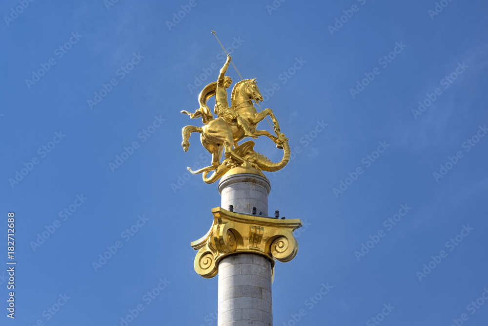 Kingdom of Georgia, Tbilisi (Tiflis), near City Council: Statue of Saint George who stays the dragon in the center of the Georgian capital blue sky in the background.