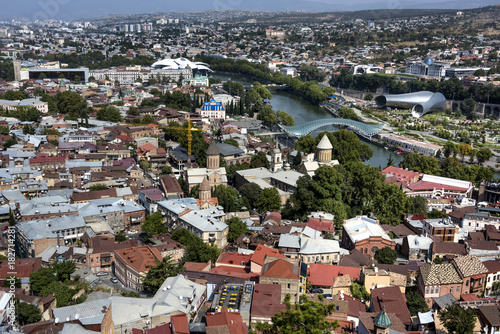 Kingdom of Georgia, Tbilisi (Tiflis): Skyline with red roofs of the Georgian capital with river, houses, churches and horizon in the background. 