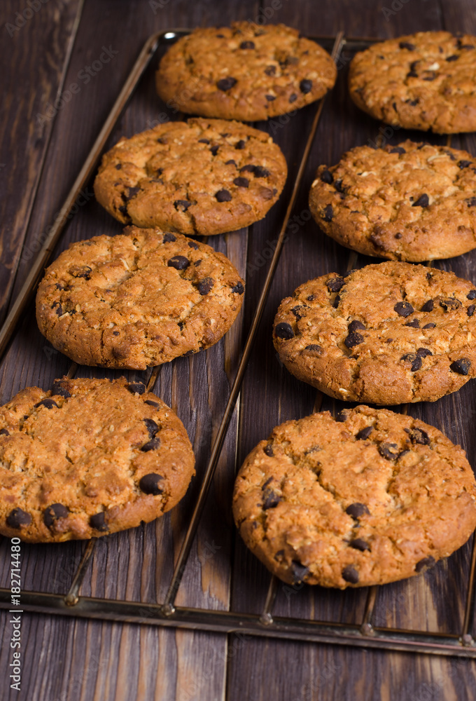Homemade oatmeal cookies on cooling rack. Wooden background. Side view Homemade oatmeal cookies on cooling rack. Wooden background. Side view