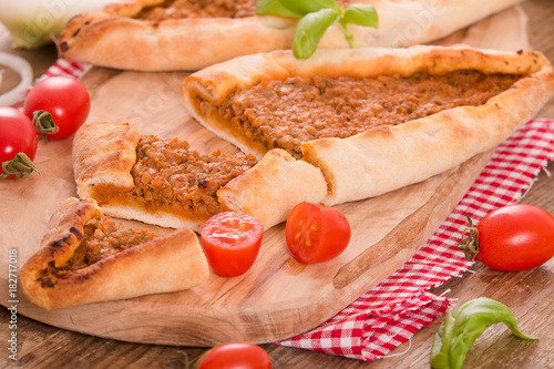 Turkish pide pizza with meat and onion. 