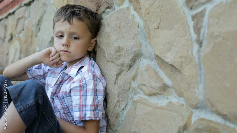 sad little boy outdoors at the day time sad little boy outdoors at the day time