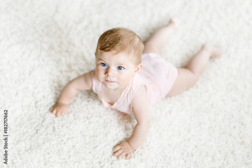 Little funny baby girl lifting body and learning to crawl. Little funny baby girl lifting body and learning to crawl.