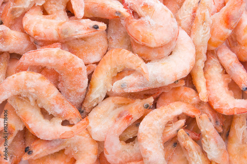 Frozen shrimps in ice. A lot of royal shrimp close-up.