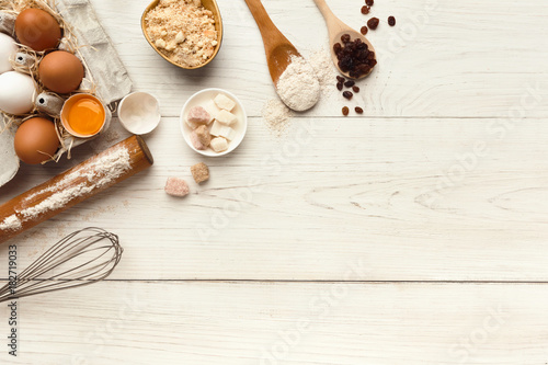 Baking background with eggs and flour on white rustic wood