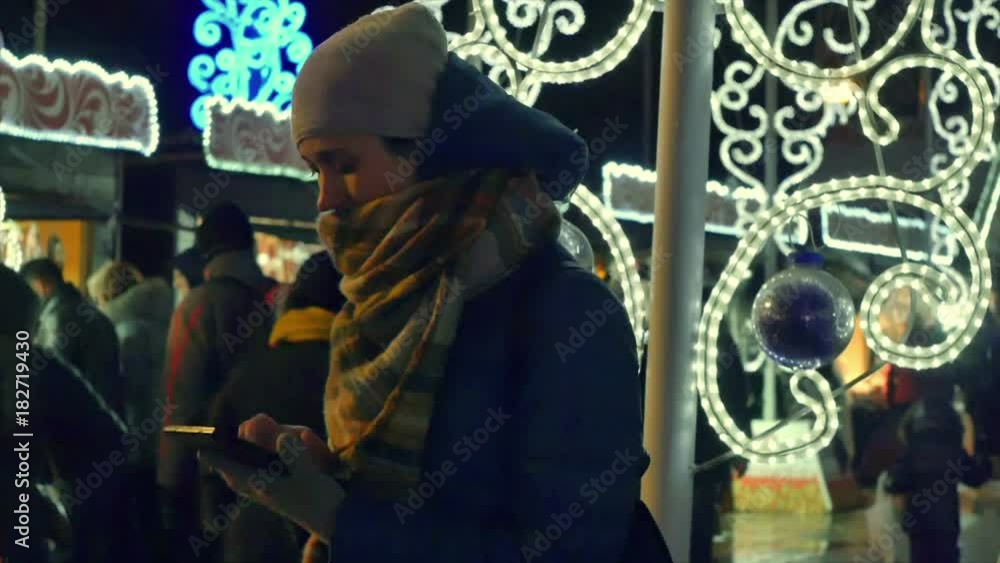 Young woman taking photo of Christmas street fair on her tablet computer Young woman taking photo of Christmas street fair on her tablet computer