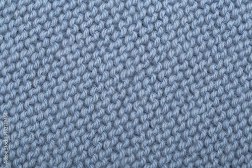 Texture of knitted woolen fabric for wallpaper and an abstract background. blue knitted texture.