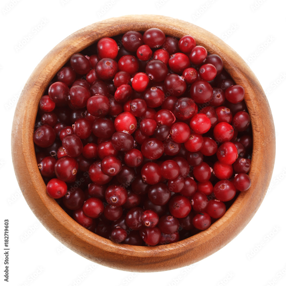 cranberries in a wooden bowl isolated on white background cranberries in a wooden bowl isolated on white background
