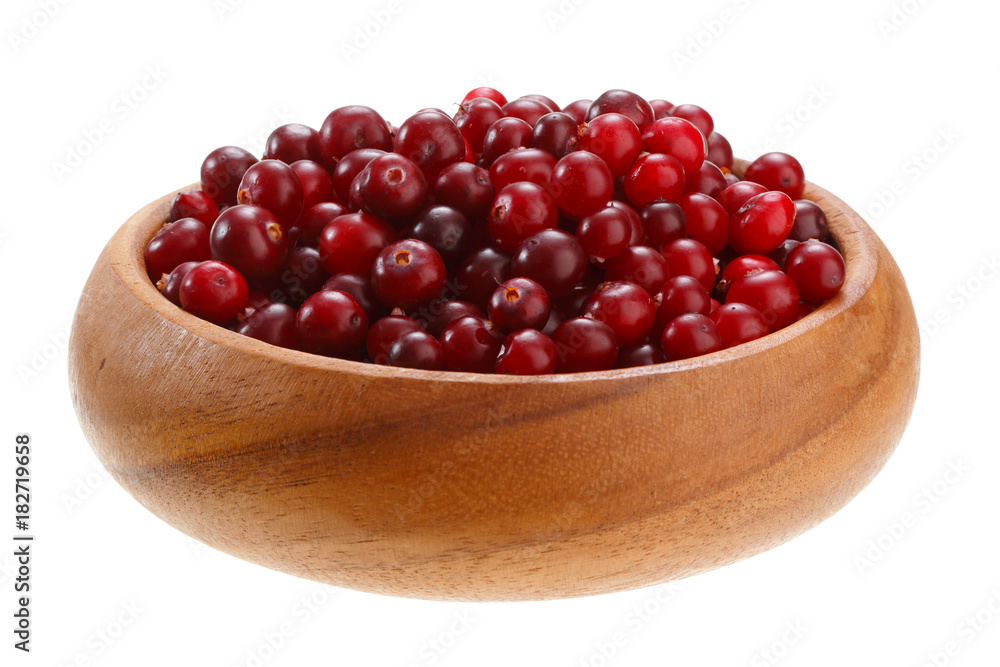 cranberries in a wooden bowl isolated on white background cranberries in a wooden bowl isolated on white background