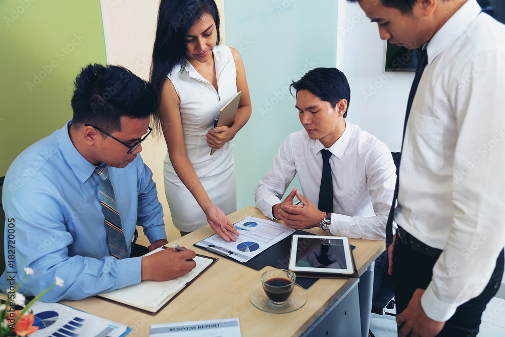 Portrait of investment agent consulting with his client while sitting at office Portrait of investment agent consulting with his client while sitting at office