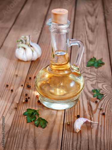 Vegetable oil in a decanter on a wooden background