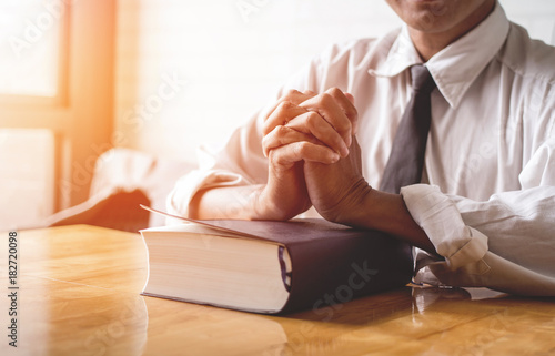 Картината върху платно close up, the pastor laid hands on the black book of the Bible, Buddhist, Catholic, Christian, prayer, and pray for blessings from God, all people are safe from harm