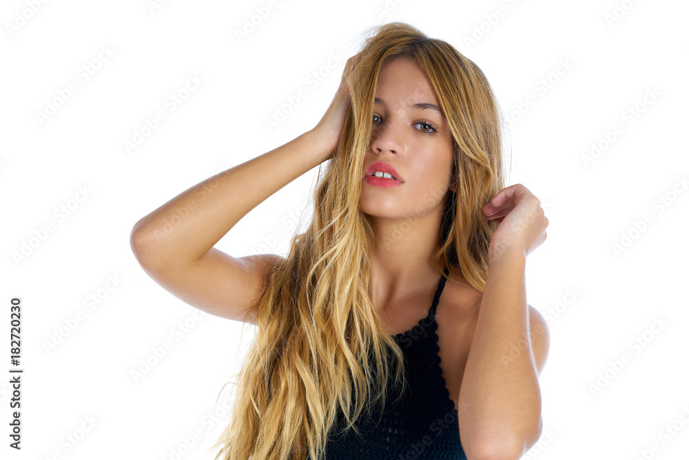 Blond teenager girl touching hair on white