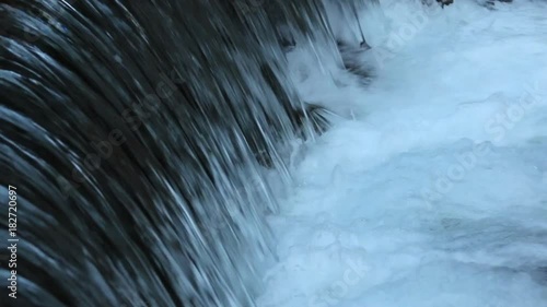 Powerful water stream flows down with foaming close-up (1080p, 25fps, sound)