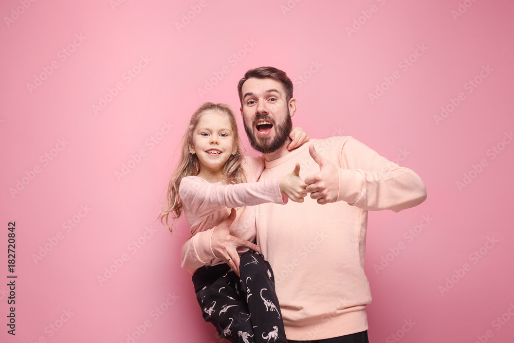 Young father with his baby daughter with thumb up - obrazy, fototapety, plakaty 