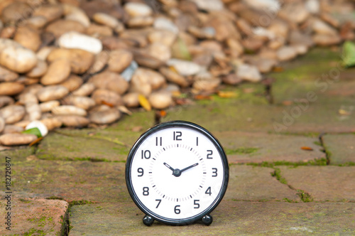 Alarm clock with stone background. photo