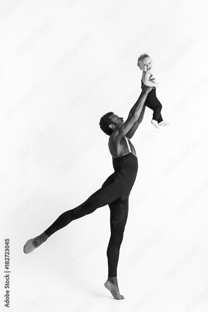 A happy family of ballet dancers on white studio background
