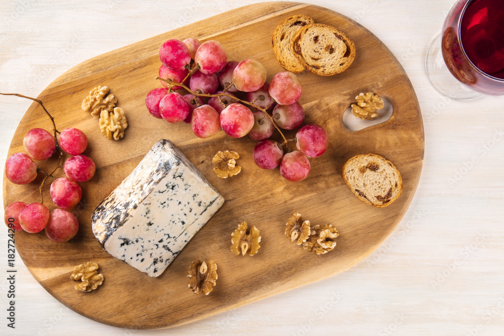 Blue cheese, shot from above with grapes, wine, and copyspace