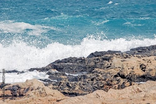 seascape of wave splash on rock at coast
