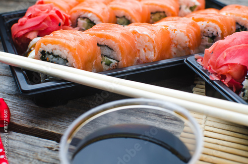 Sushi in a black container on a wooden table colorful and beautiful photo