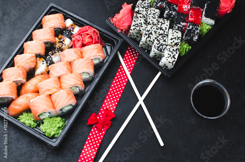 Sushi in a black container on a wooden table colorful and beautiful photo