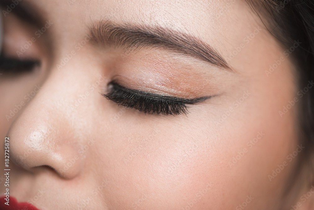 Elegance close-up of beautiful female eye with fashion eye shadow and eyeliner.