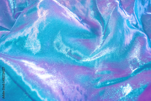 Purple and turquoise iridescent fabric. photo