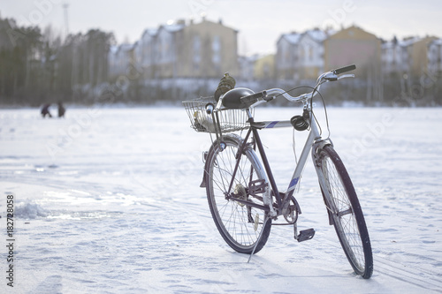 bike on winter fishing in the background of apartment buildings and two fishermen, toned