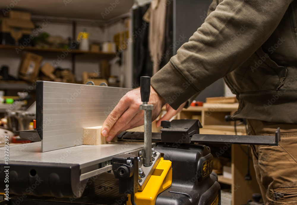 Woodworking, planing wood on a jointer Woodworking, planing wood on a jointer