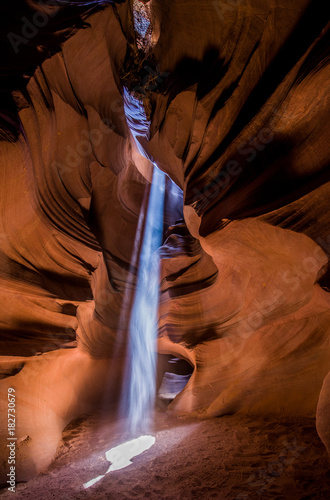 Streak of light falling down on the floor of a slot canyon (Antelope canyon in Arizona, USA)