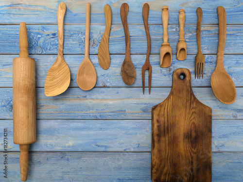 wooden kitchen accessories on a blue wooden table. 