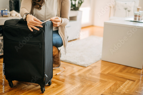 Hand luggage measurement using measuring tape before going on vacation.