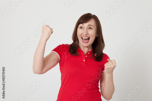 Happy middle aged woman on white background. Red blank T-shirt with copy space. Mother day