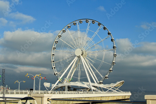 Baku eye on Seaside Boulevard. Baku ferris wheel. In the sunny winter day. Deserted boulevard © Khrystyna Bohush