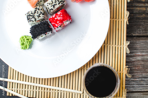 on the plate is white, lined with different rolls, sushi photo