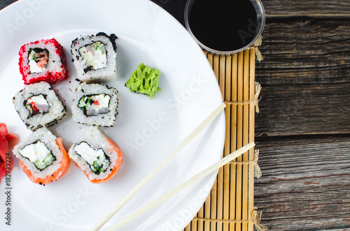 on the plate is white, lined with different rolls, sushi photo