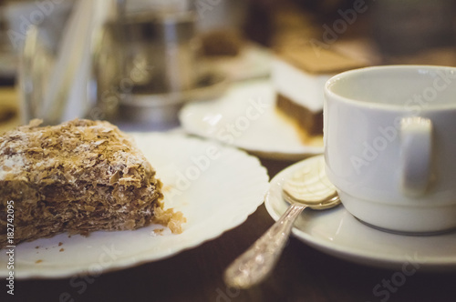 A puff cake on a table in a cafe. Close-up, soft focus. Toning in the style of instagram.