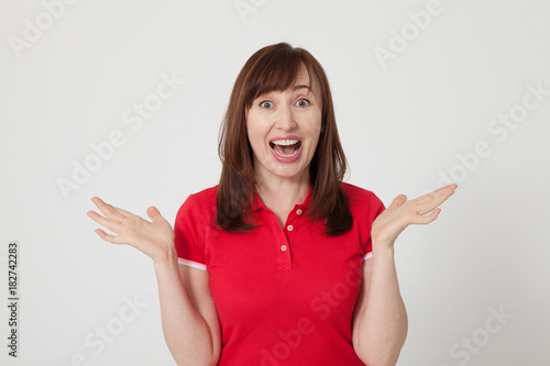Wallpaper Mural Portrait of brunette surprised happy woman in blank red t-shirt with copy space on white background. Mock up. Menopause Torontodigital.ca