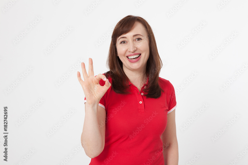 Smiling attractive middle aged woman showing thumbs up, okay. Isolated. Copy space Smiling attractive middle aged woman showing thumbs up, okay. Isolated. Copy space