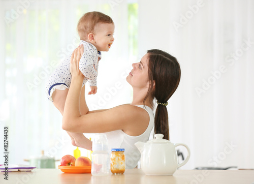 Mother holding cute baby in...