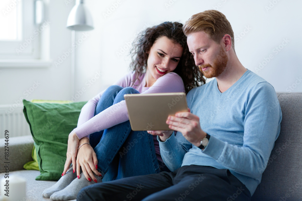 Young couple using digital tablet at home Young couple using digital tablet at home
