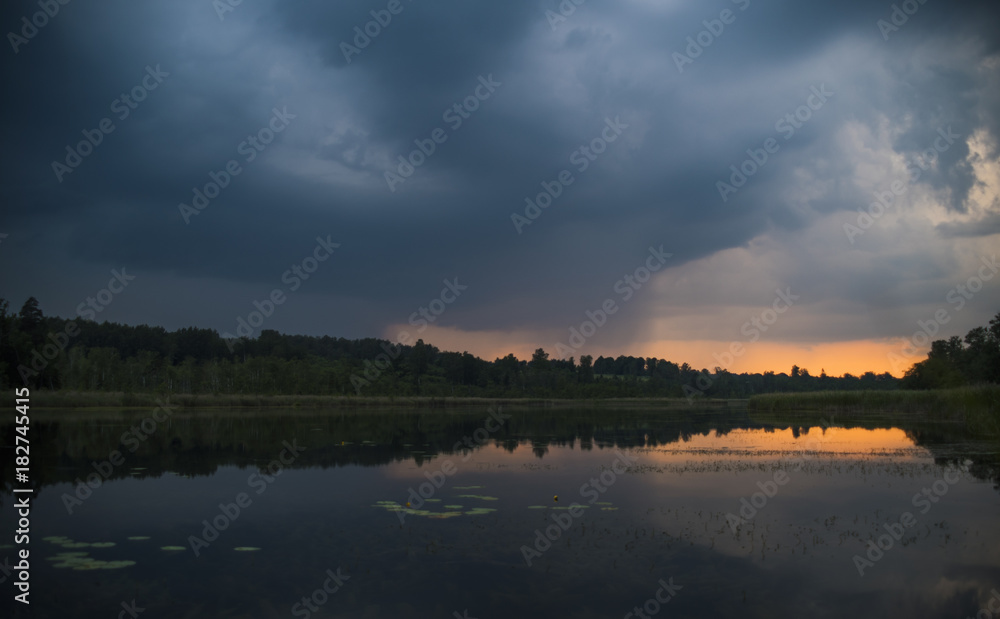 Dark clouds over calm lake