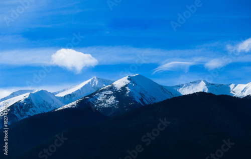 Mountain snow peak, beautiful natural winter backdrop. Ice top of the hill, blue sky background. Alpine landscape. © alicefoxartbox